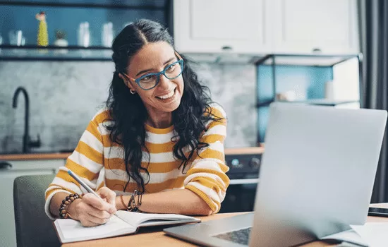 Women in blue glasses taking notes