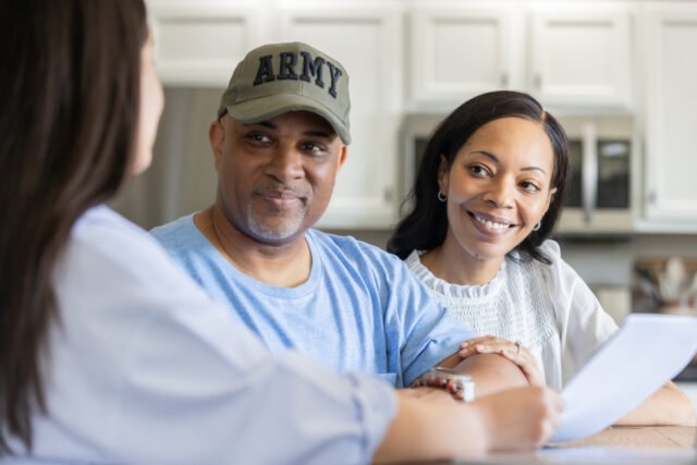 A retired soldier and his wife discuss money planning with a professional advisor
